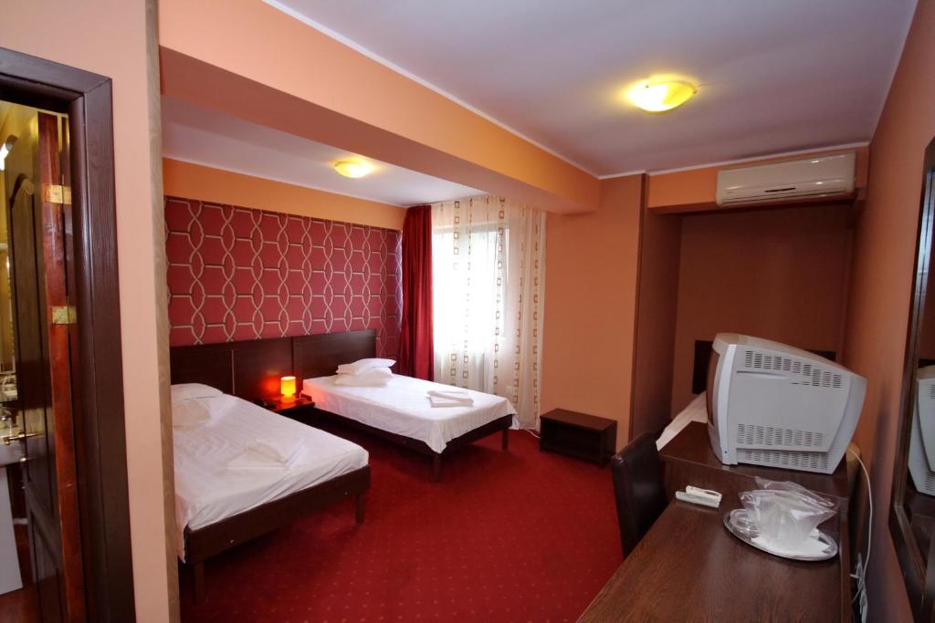 Postel nebo postele na pokoji v ubytování Hotel City