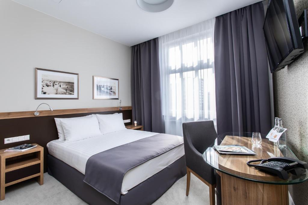 Postel nebo postele na pokoji v ubytování Jakubowy Hotel