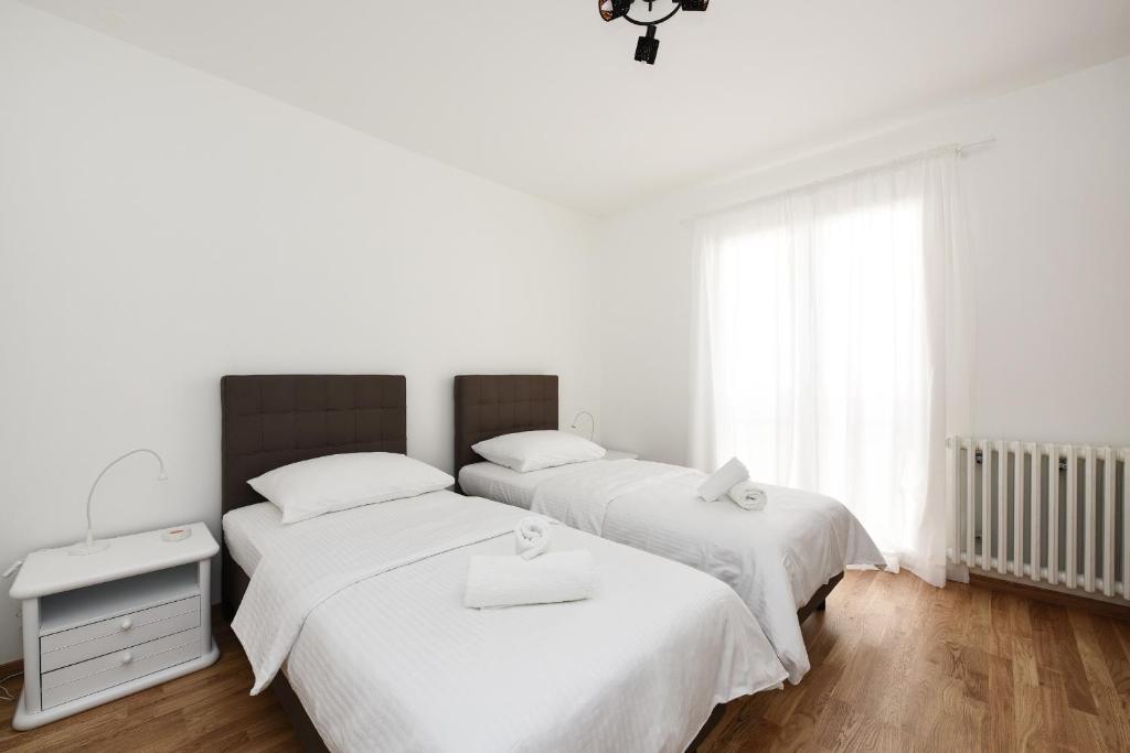 Posteľ alebo postele v izbe v ubytovaní July Apartment