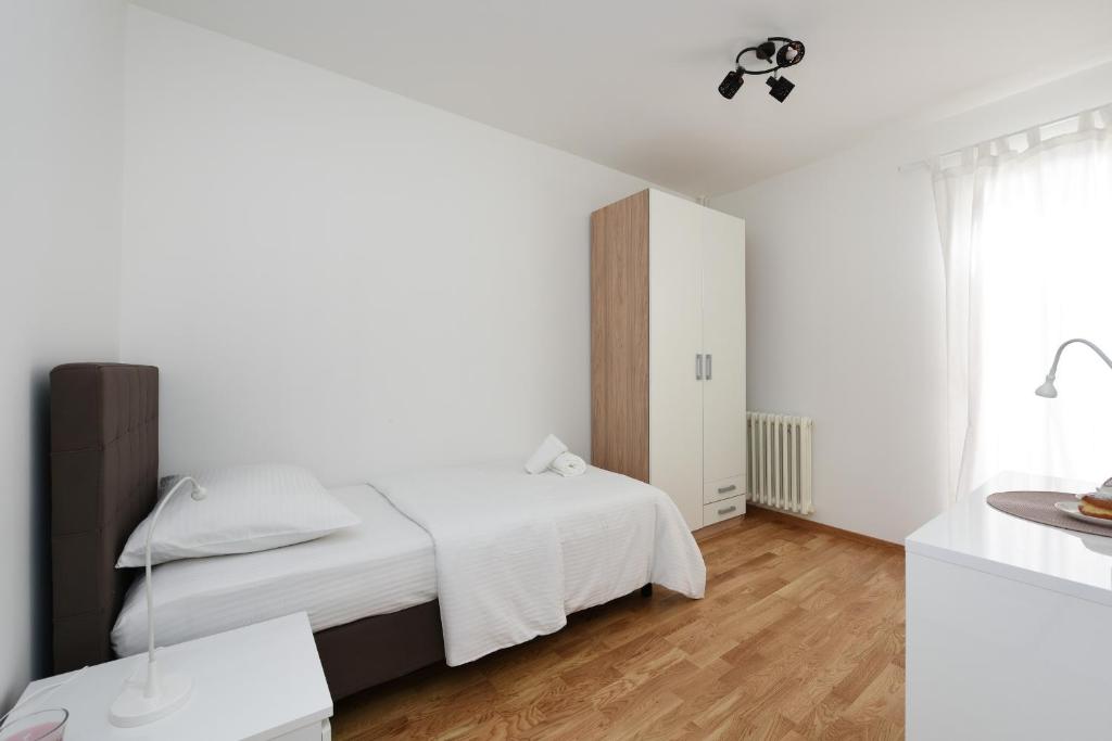 Posteľ alebo postele v izbe v ubytovaní July Apartment
