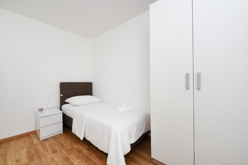 Posteľ alebo postele v izbe v ubytovaní July Apartment