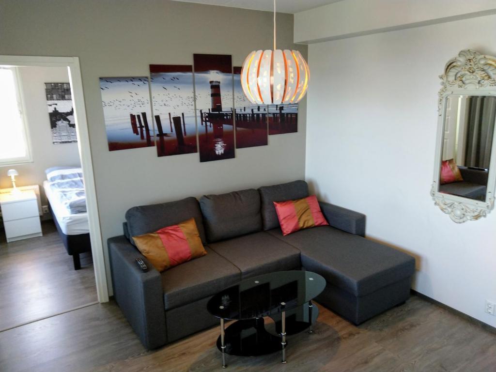 a living room with a couch and a table at Pro Apartments 4 in Vaasa