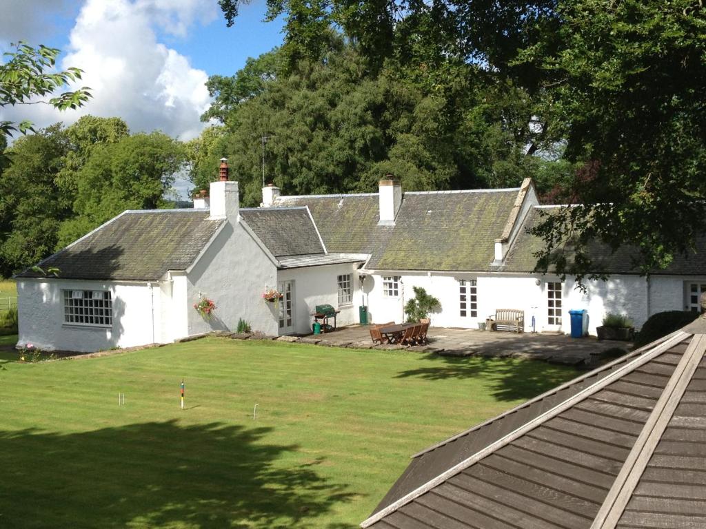 a white house with a large yard in front of it at South Craighall B&B in Eaglesham