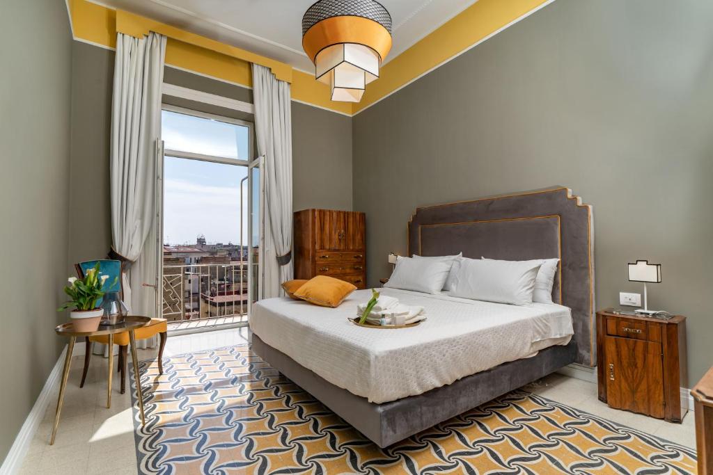 a bedroom with a bed and a large window at IL FIORE D'ORO LUXURY in Naples