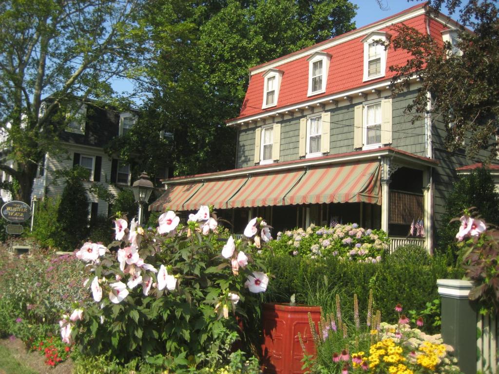 a house with a flower garden in front of it at Thomas Webster House in Cape May