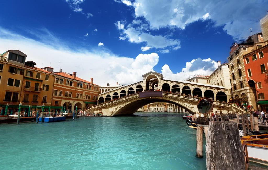 a bridge over a river in a city at Delicious Apartament near St. Mark Square in Venice