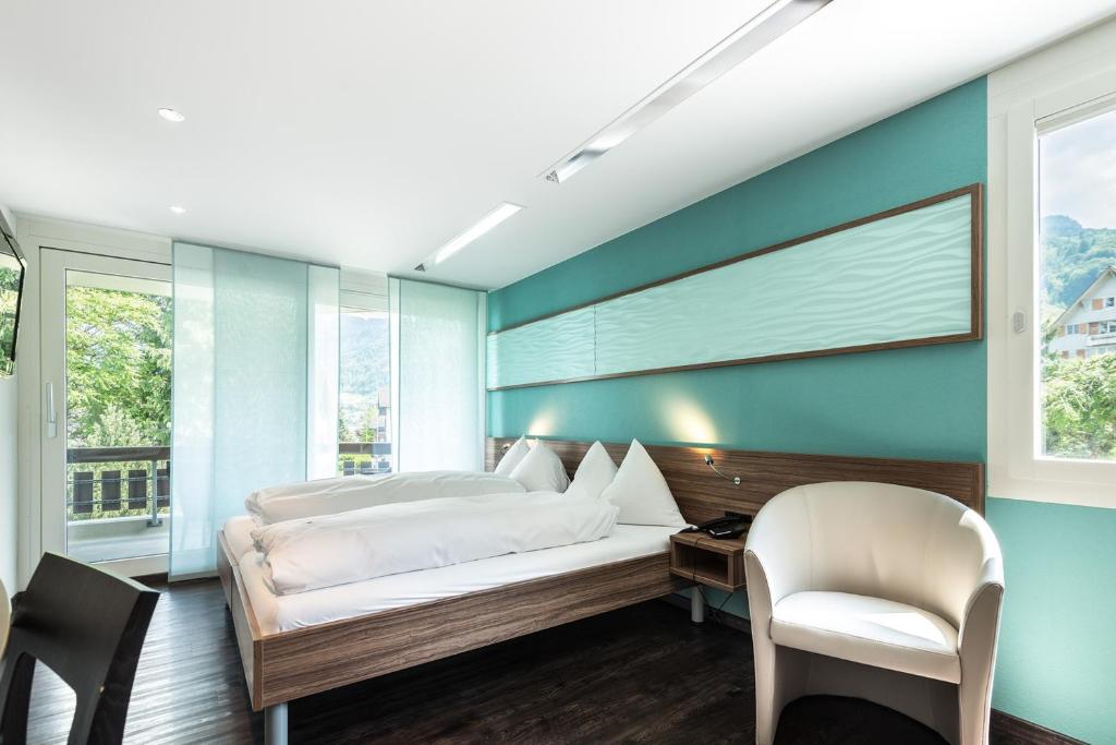 Postel nebo postele na pokoji v ubytování Superior Hotel Nidwaldnerhof