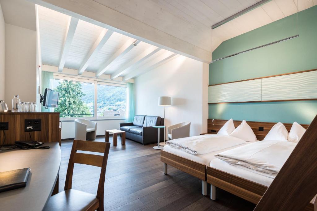 Postel nebo postele na pokoji v ubytování Superior Hotel Nidwaldnerhof