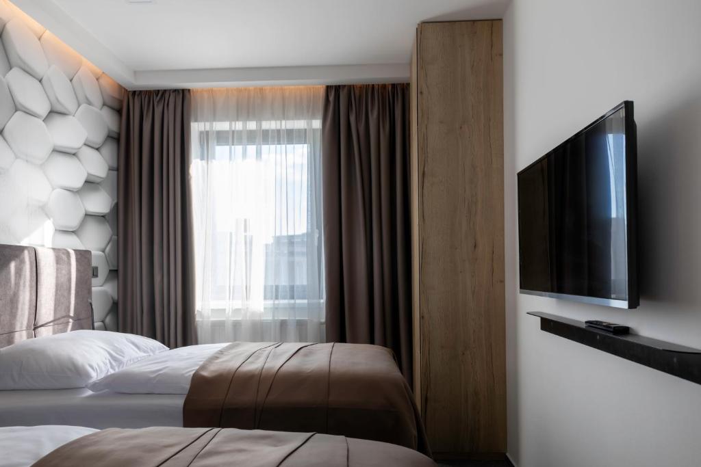 Postel nebo postele na pokoji v ubytování 4 SMART HOTEL