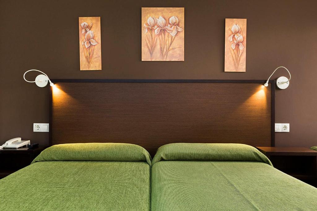 A bed or beds in a room at Hotel San Lázaro