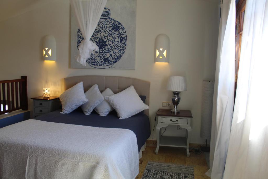 a bedroom with a bed with blue and white pillows at Apartamento Frida Faro Park in Playa Blanca