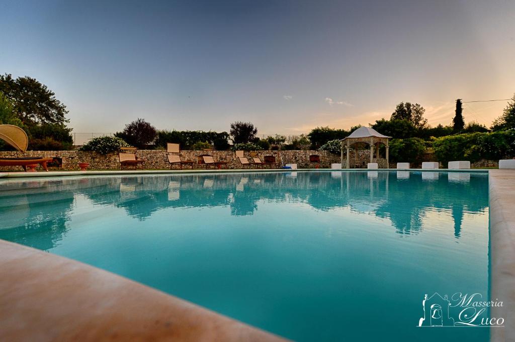 a large swimming pool with a gazebo at Masseria Luco in Martina Franca