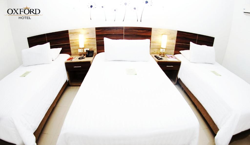 Postel nebo postele na pokoji v ubytování Hotel Oxford Barranquilla