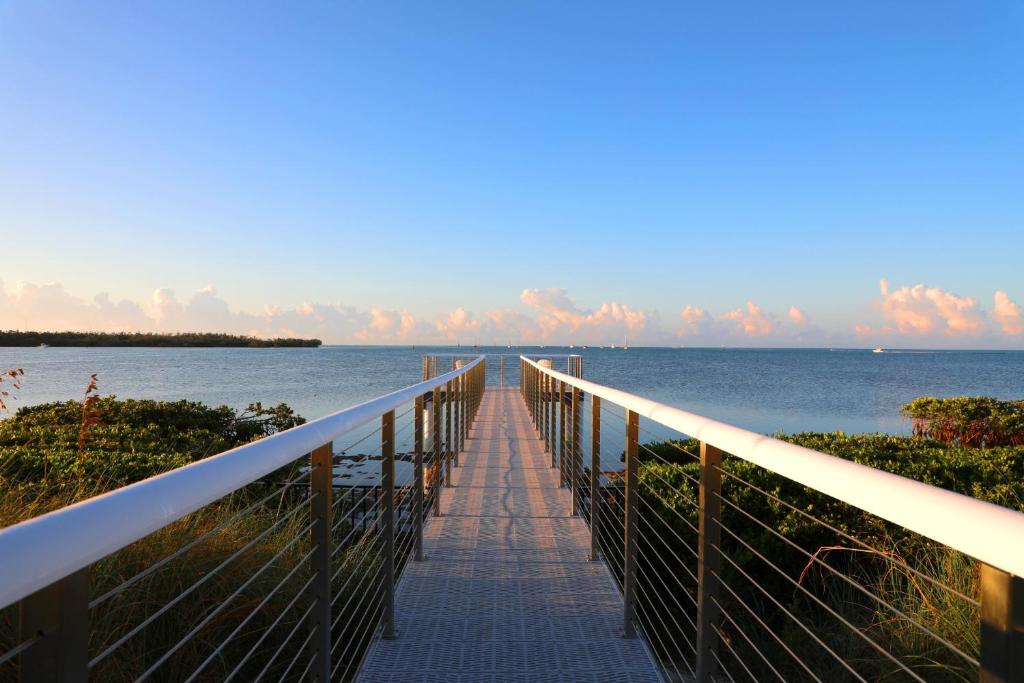 a boardwalk leading to the ocean on a beach at Isla Bella Beach Resort & Spa - Florida Keys in Marathon