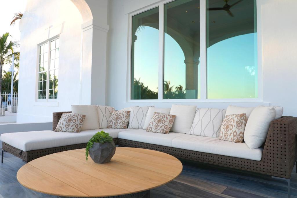a living room with a white couch and a wooden table at Isla Bella Beach Resort & Spa - Florida Keys in Marathon