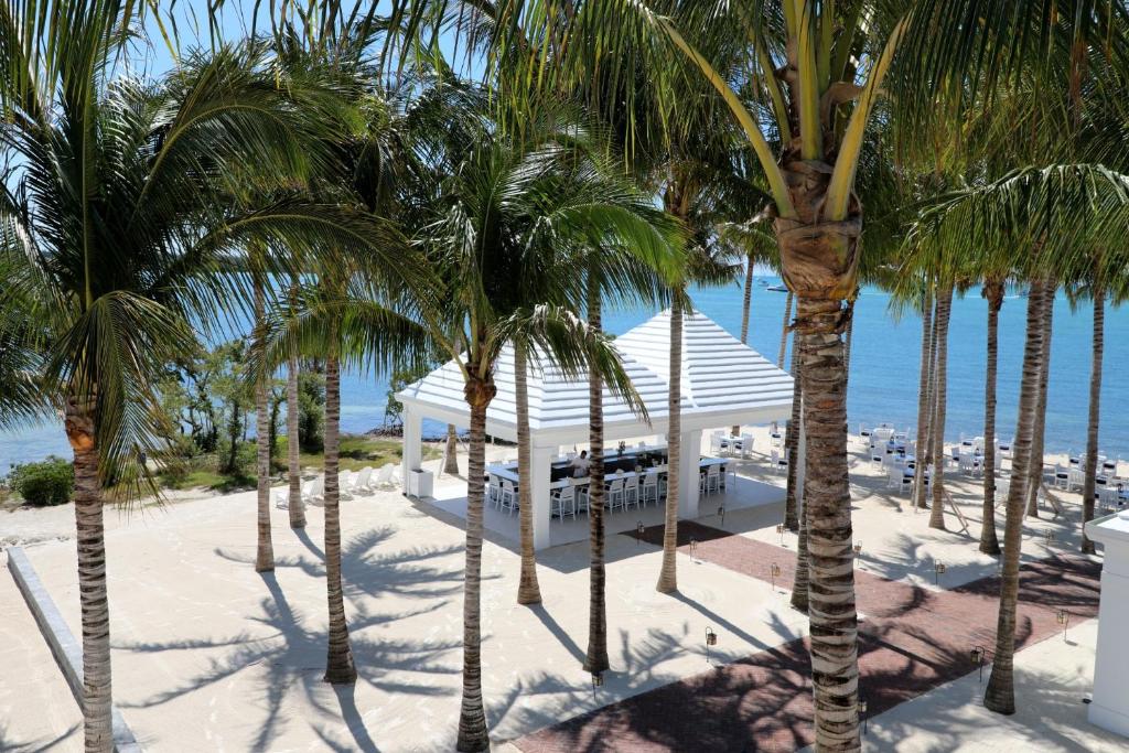a resort with palm trees in front of the ocean at Isla Bella Beach Resort & Spa - Florida Keys in Marathon