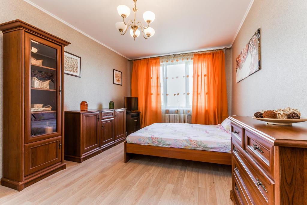 a bedroom with a bed and cabinets and a window at Apartments on Volgina in Moscow