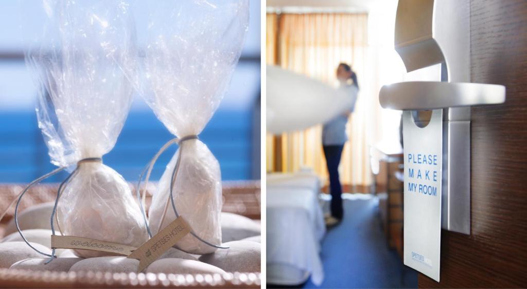 a pair of hour glasses sitting on a bed with a sign at Spetses Hotel in Spetses