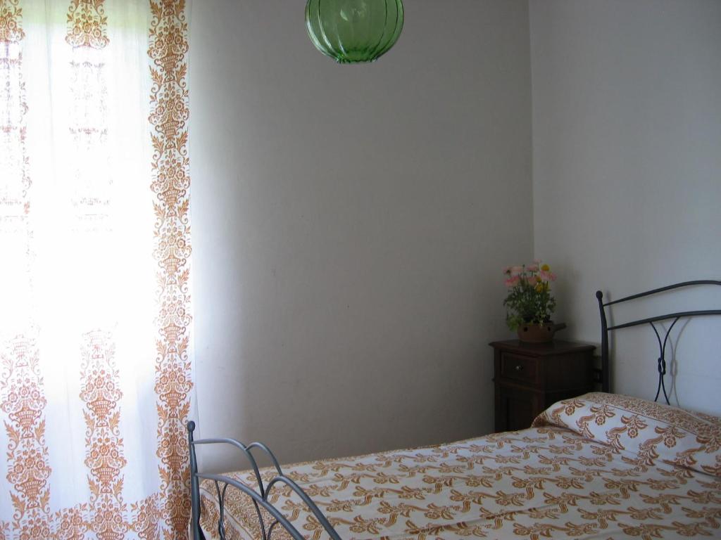 A bed or beds in a room at La Fattoria