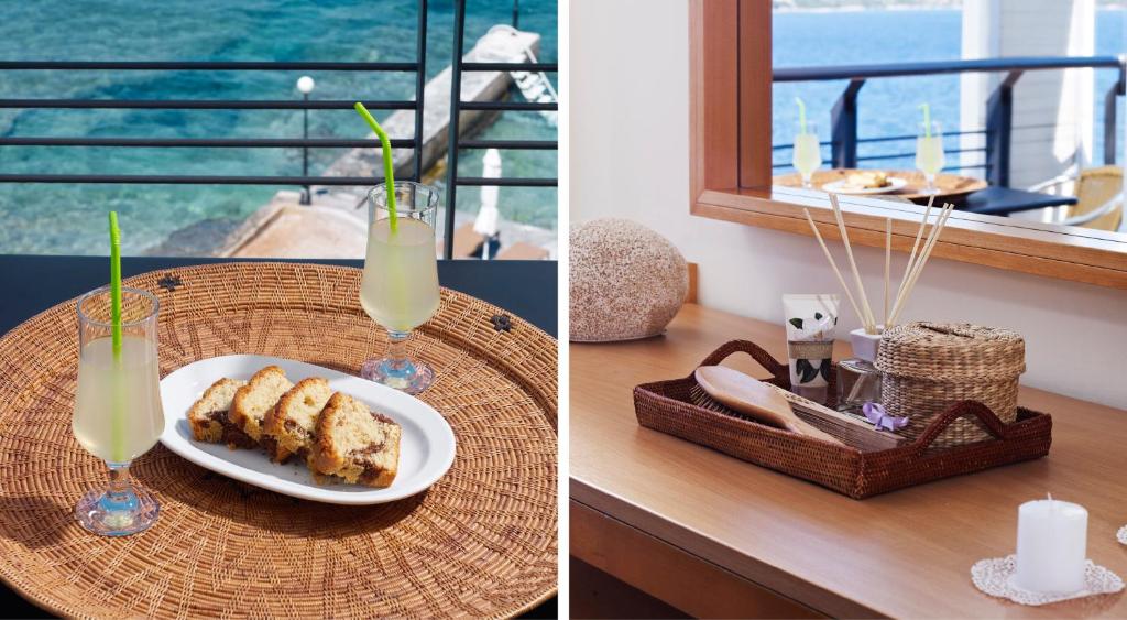 a table with a plate of food and a glass of juice at Spetses Hotel in Spetses