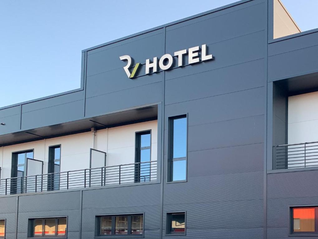 a hotel sign on the side of a building at Self Check-in Hotel von Rotz in Wil