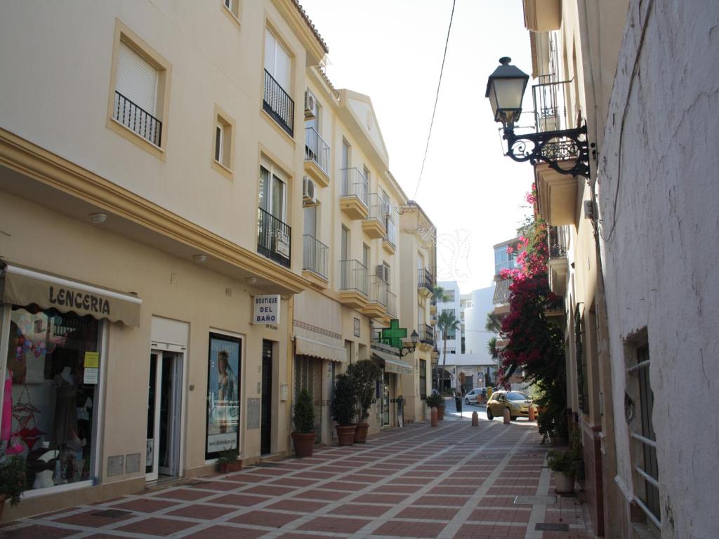 an empty street in a city with buildings at Apartamentos Velasco in Torremolinos