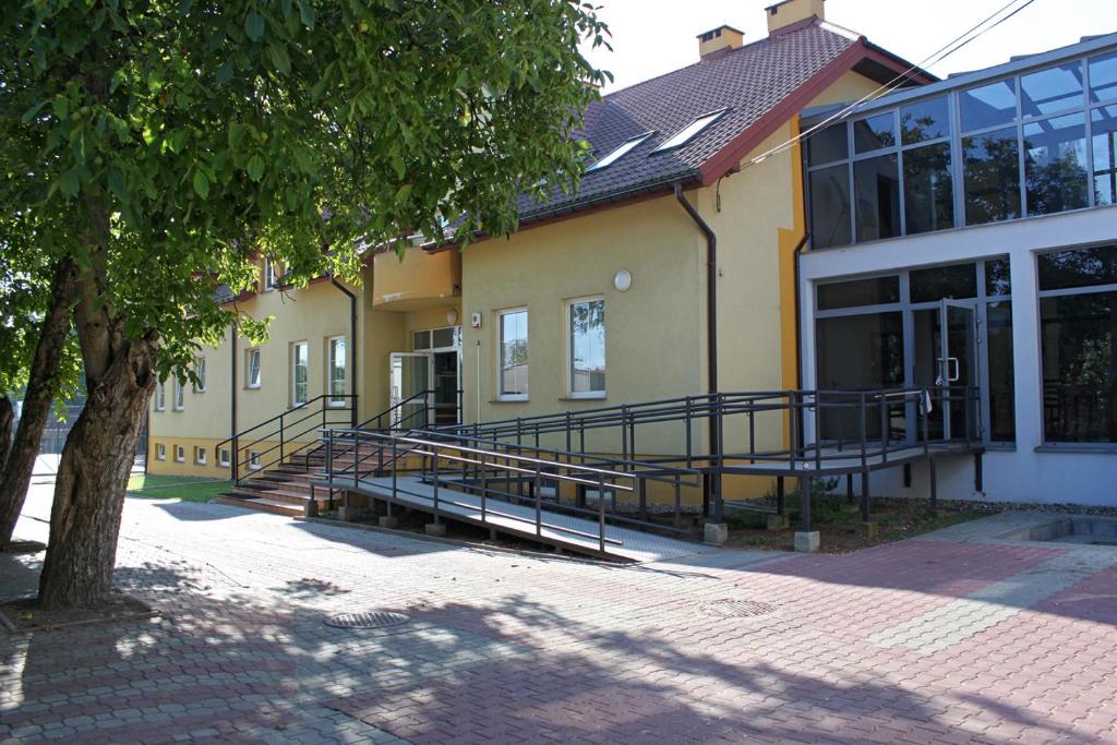 a building with stairs in front of a building at Integracyjne Centrum Opieki Wychowania Terapii in Serock