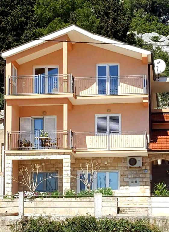 a large building with balconies on top of it at Apartman Roza in Ploče