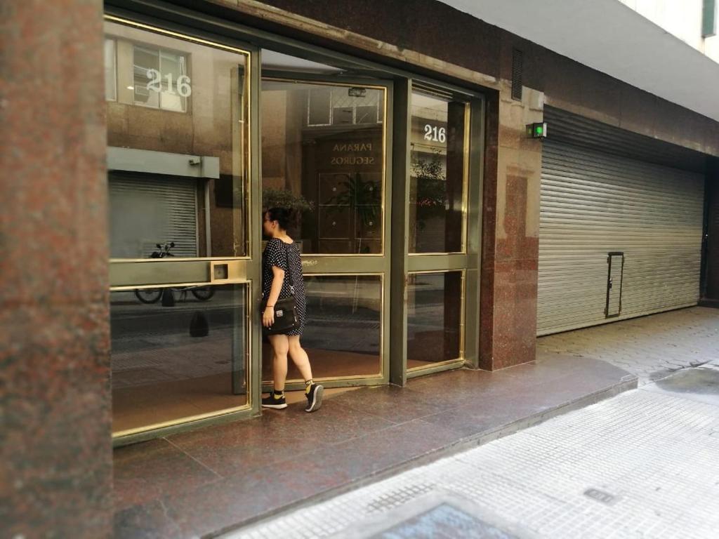 a woman walking out of a store door at Maipuhc in Buenos Aires