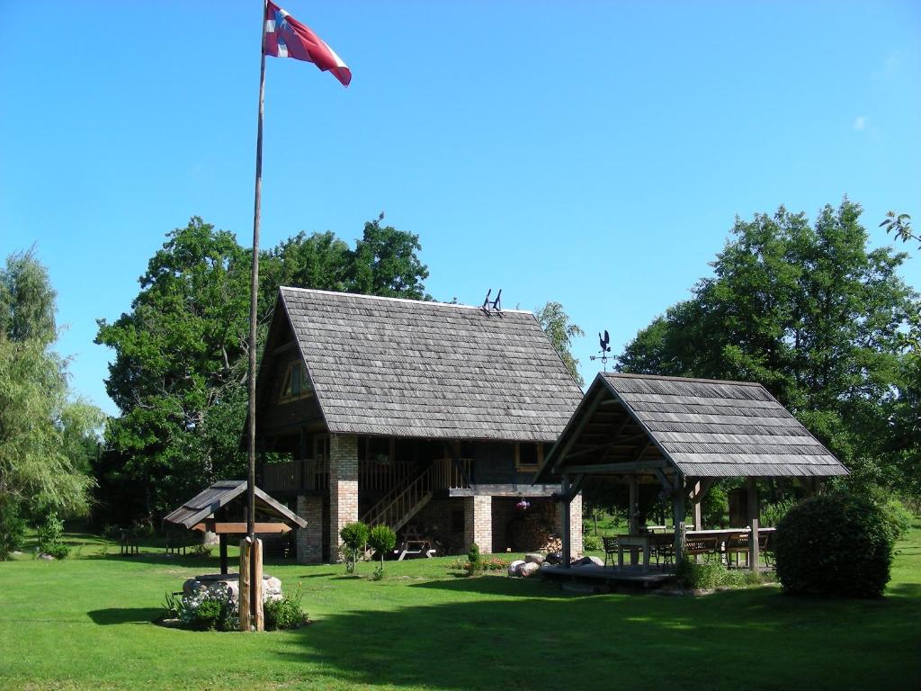 a pavilion with an american flag in a park at Griķi in Kalnišķi