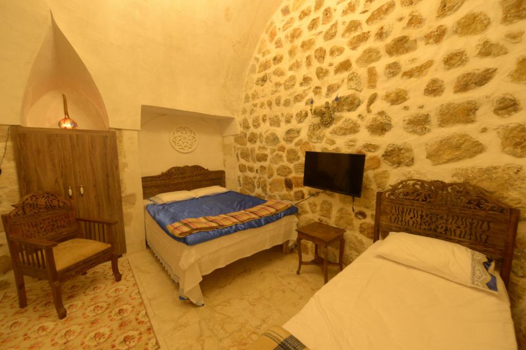 Postel nebo postele na pokoji v ubytování MERDİN BOUTİQUE HOTEL