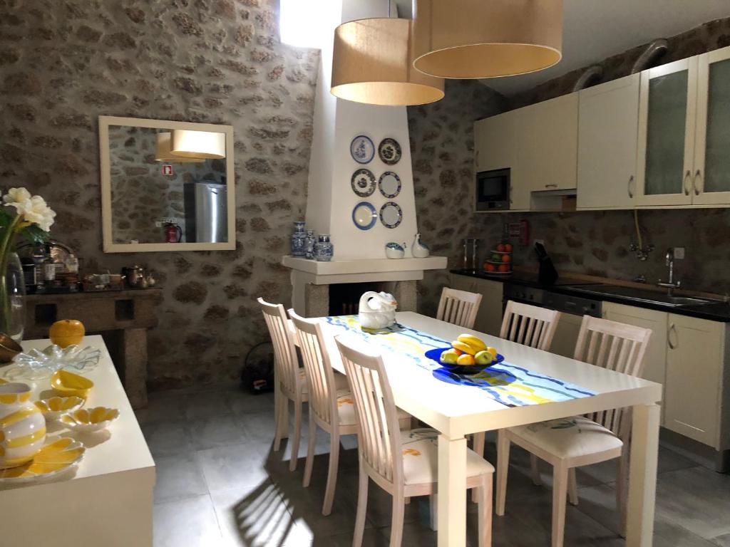 a kitchen with a white table with chairs and a kitchen at 3 Marias - Nº20 - T1 in Lousa