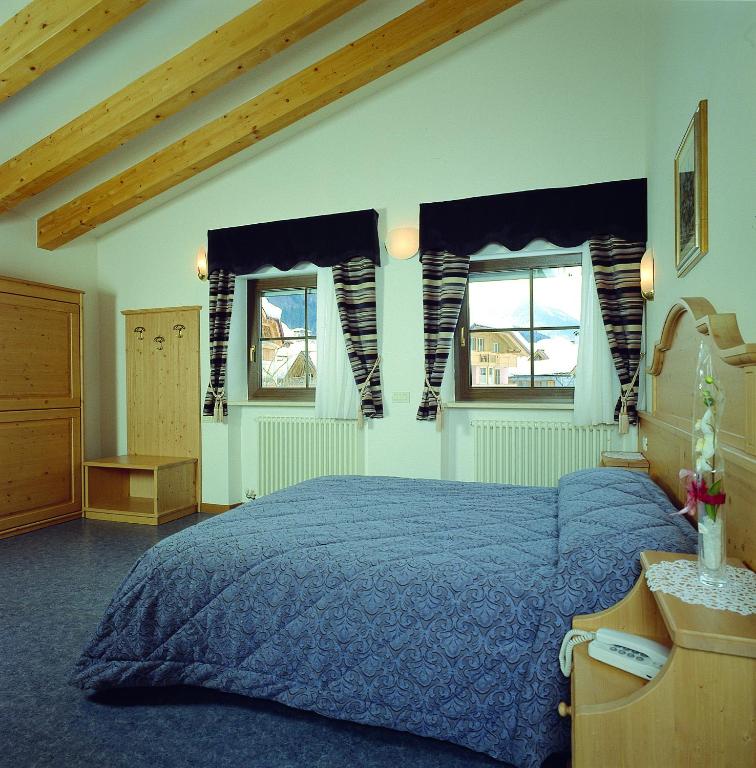 Postel nebo postele na pokoji v ubytování Hotel Al Plan Andalo