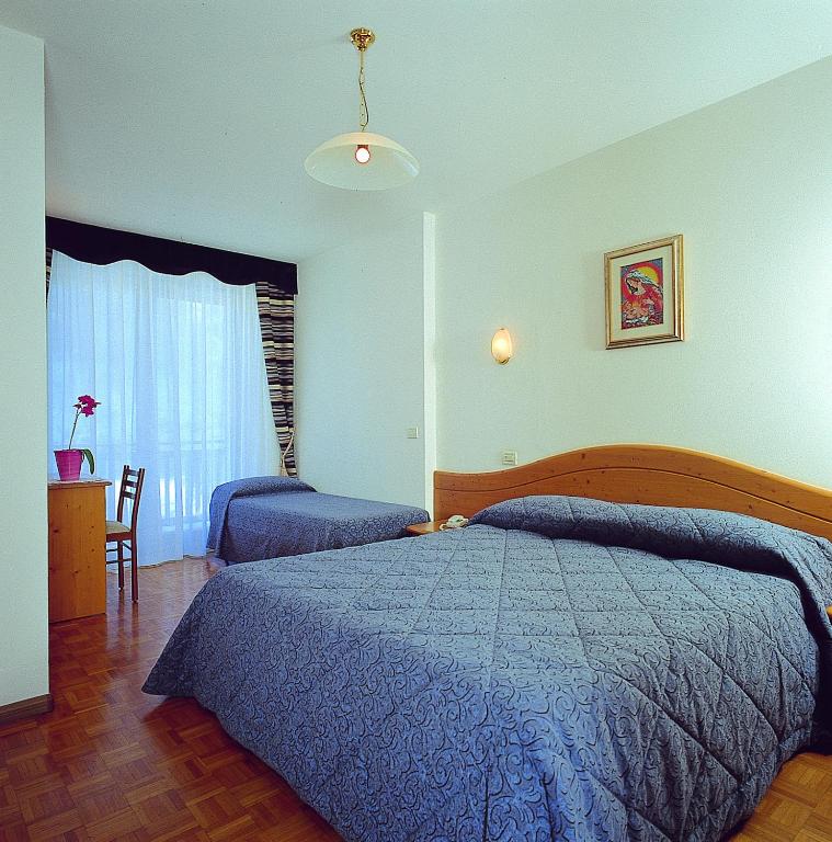 Postel nebo postele na pokoji v ubytování Hotel Al Plan Andalo