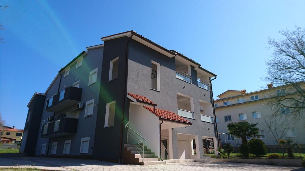 a building that is next to a building at Apartments Barbic in Medulin