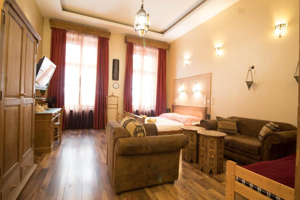a living room with a couch and a bed at Budapest Royal Suites in Budapest