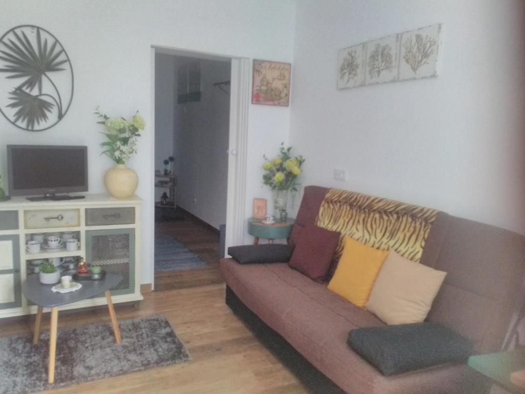 a living room with a couch and a tv at Além Tejo in Elvas