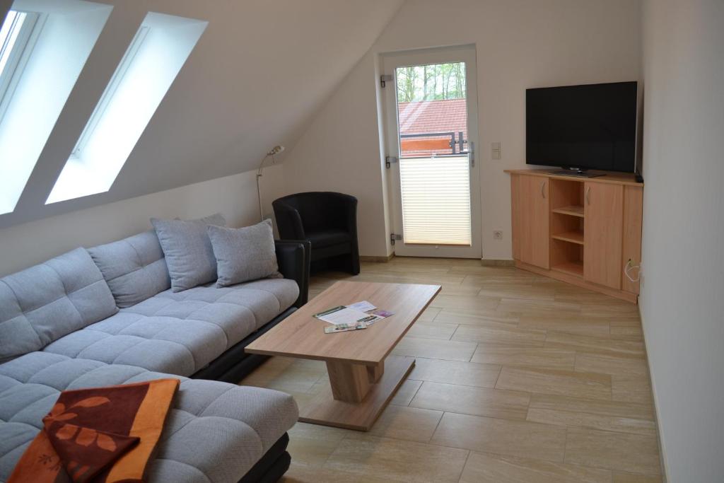 a living room with a couch and a table at Appartement Dachgeschoss in Schlepzig