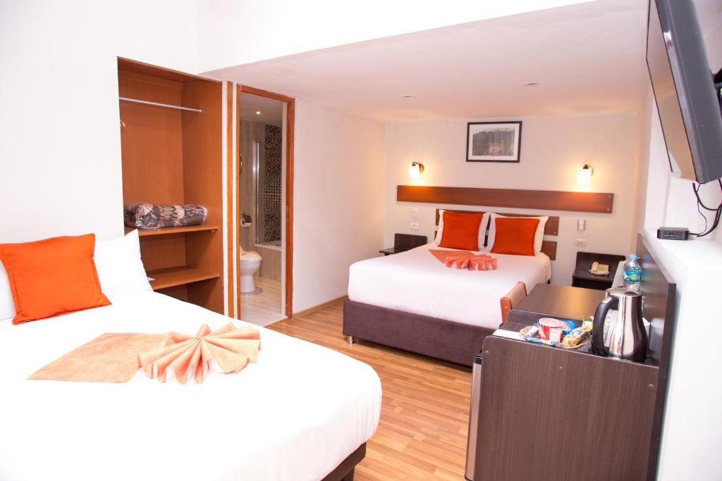 Postel nebo postele na pokoji v ubytování Hotel Arcangel