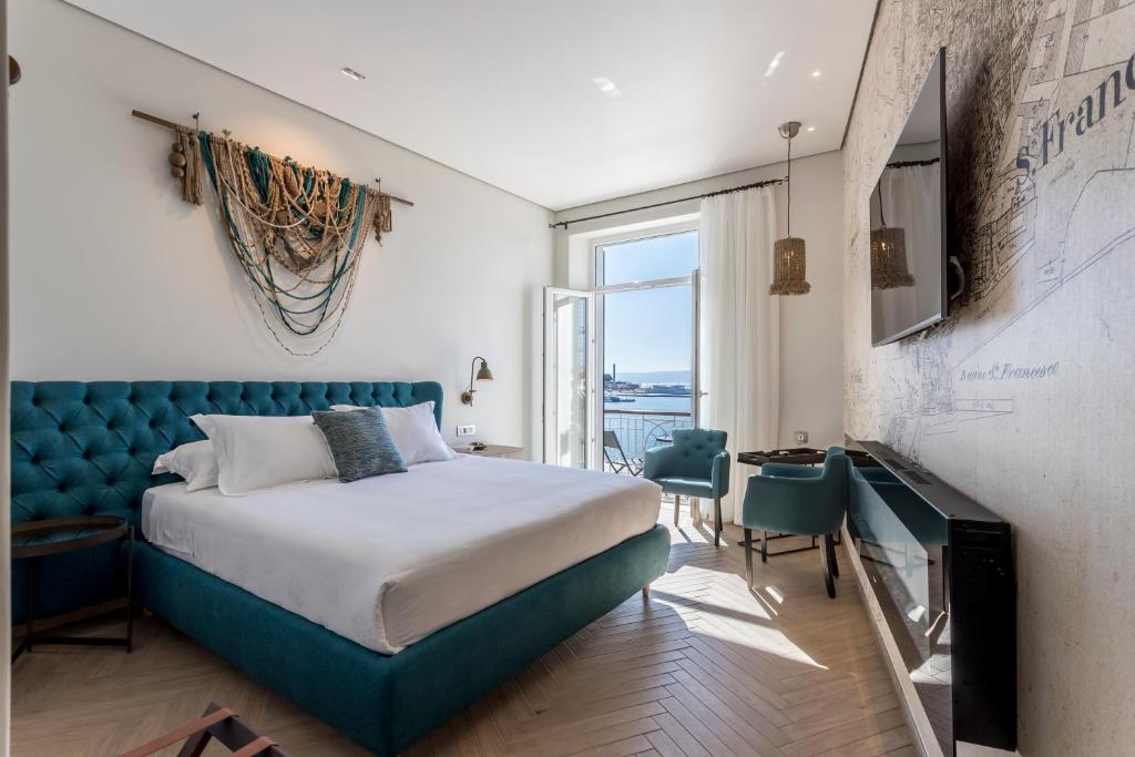 a bedroom with a bed with a blue headboard at Seaview Luxury Retreat in Split