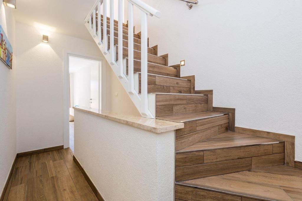 a staircase in a home with wooden floors at Apartment in Vrbnik/Insel Krk 36845 in Vrbnik