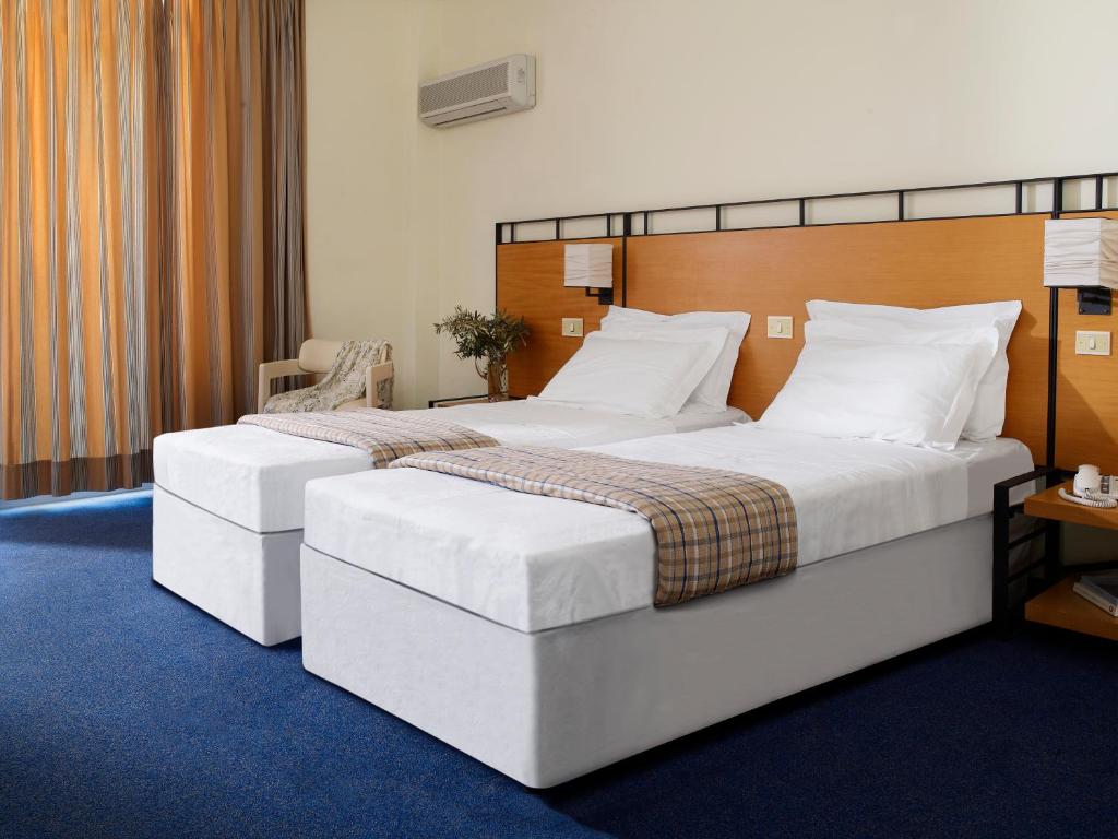 two twin beds in a hotel room with at Spetses Hotel in Spetses