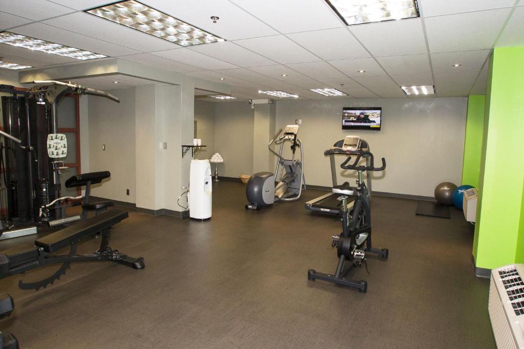 a gym with several exercise equipment in a room at Coast Hotel & Convention Centre in Langley