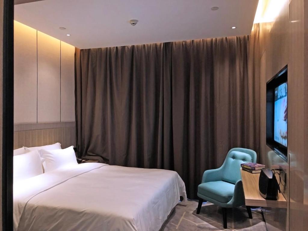 TV a/nebo společenská místnost v ubytování Paco Hotel Guangzhou Baiyun Airport Liantang Metro