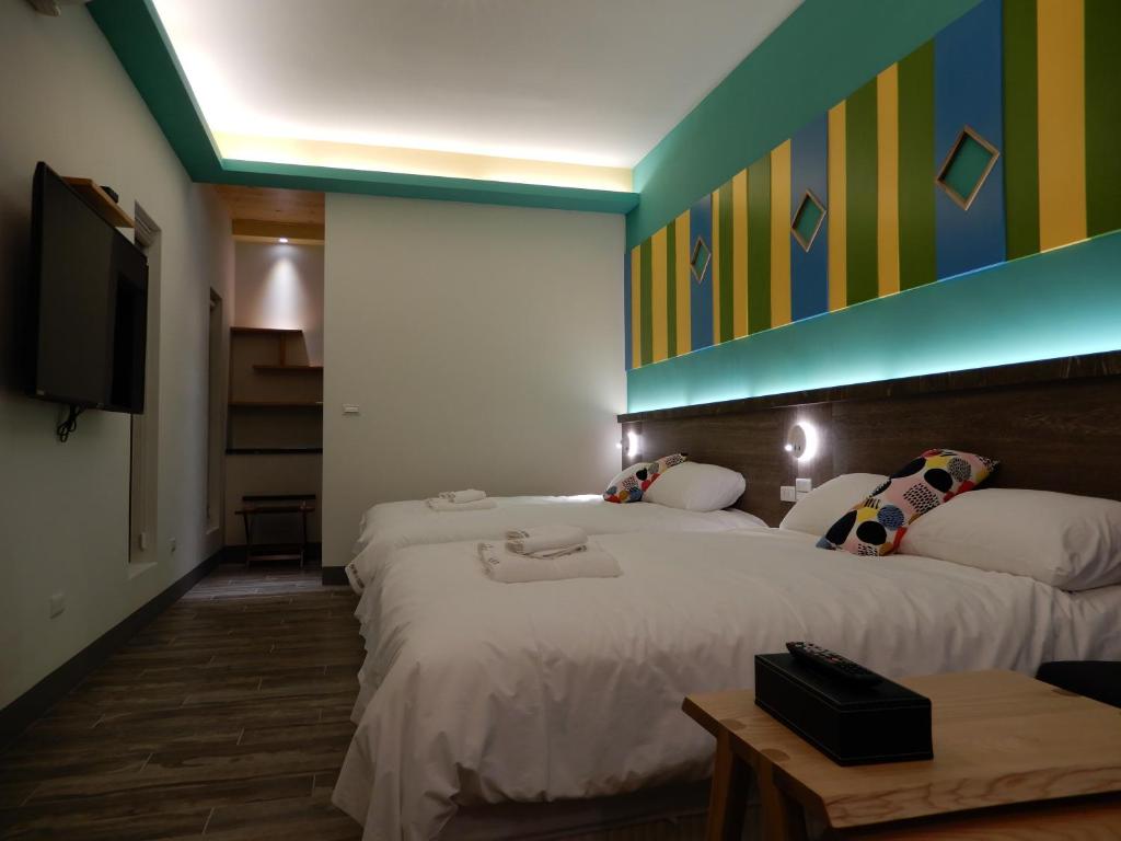 Postel nebo postele na pokoji v ubytování Happy Wing Guesthouse