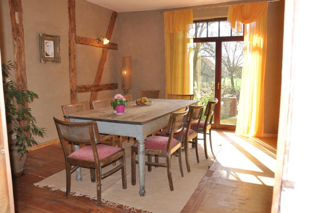 a dining room with a wooden table and chairs at Ferienhaus Caselow 23 in Bergholz