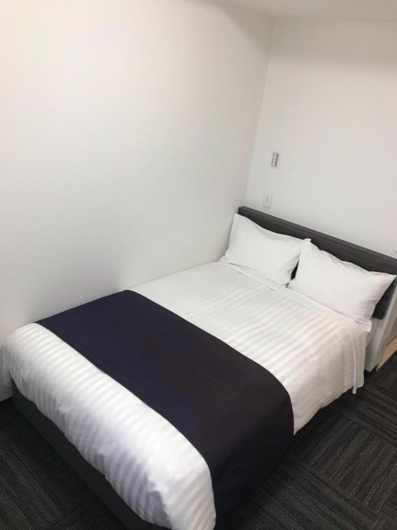 Postel nebo postele na pokoji v ubytování Okachimachi Urban Hotel