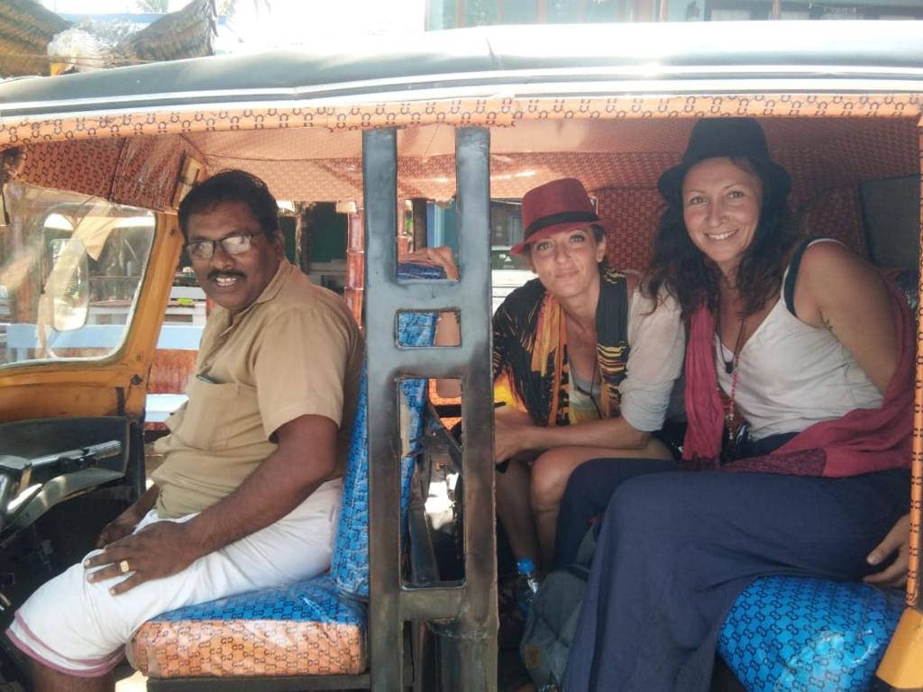 three people sitting in the back of a van at Cherai Ocean View Home in Cherai Beach