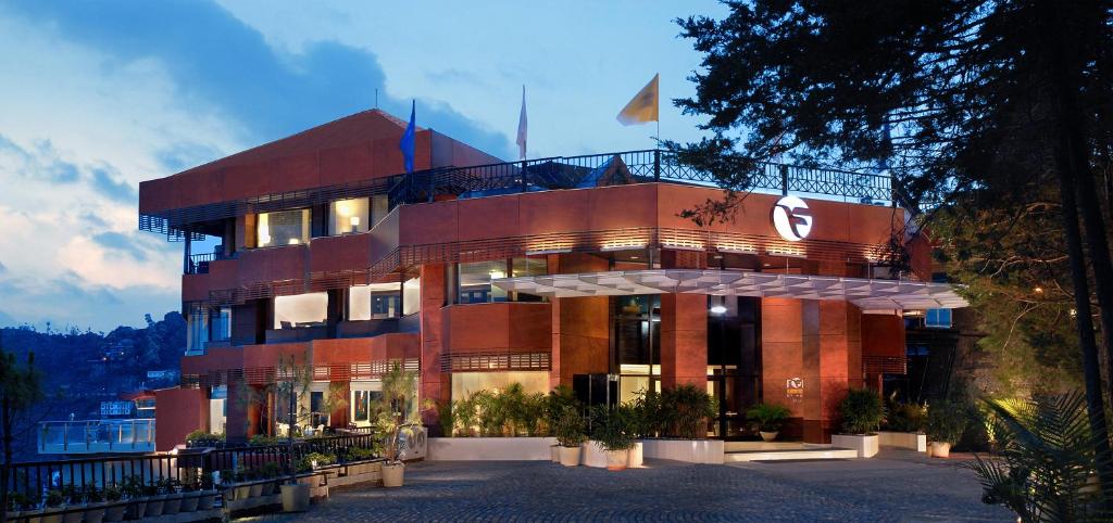 a building with a flag on top of it at Fortune Resort Grace, Mussoorie - Member ITC's Hotel Group in Mussoorie