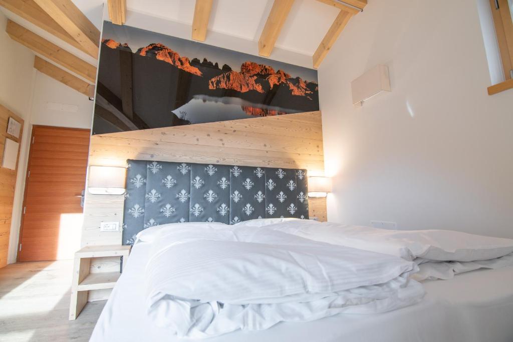 Postel nebo postele na pokoji v ubytování Hotel Eccher 3 stelle Superior